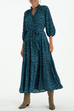 Zoey Jo Belted Tiered Maxi Dress in teal floral print with ruffle collar and 3/4 sleeves, styled with tan suede boots.