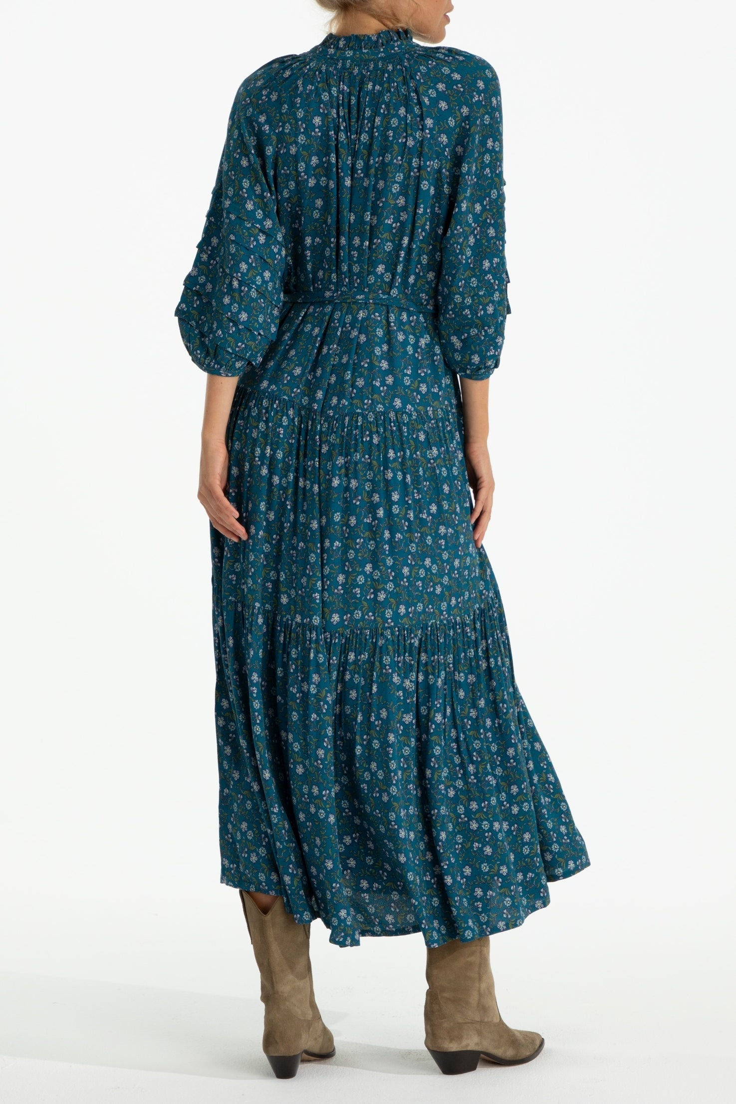 Back view of Zoey Jo Belted Tiered Maxi Dress showcasing tiered skirt and waist tie detail in teal floral pattern.