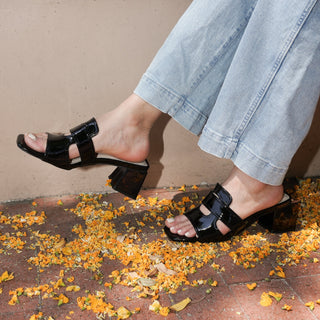 Model wearing Deborah | Black Patent Heels outdoors, styled with cropped jeans, showcasing the glossy finish and chic heel.