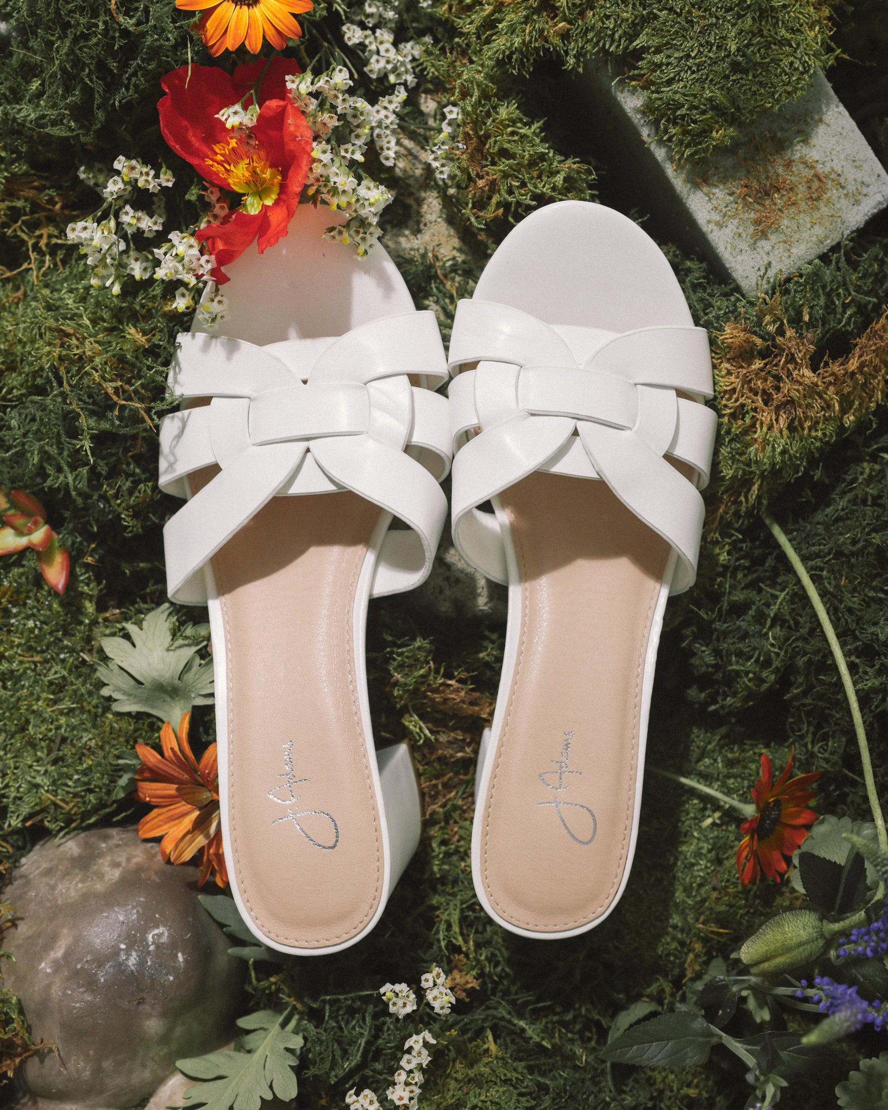 Nori | White Sandals by J.Adams styled in a floral outdoor setting, emphasizing their fresh and fashionable appeal.