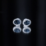 6X8MM Oval London Blue Topaz Stud Earrings with Moissanite Halo