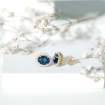 6X8MM Oval London Blue Topaz Stud Earrings with Moissanite Halo