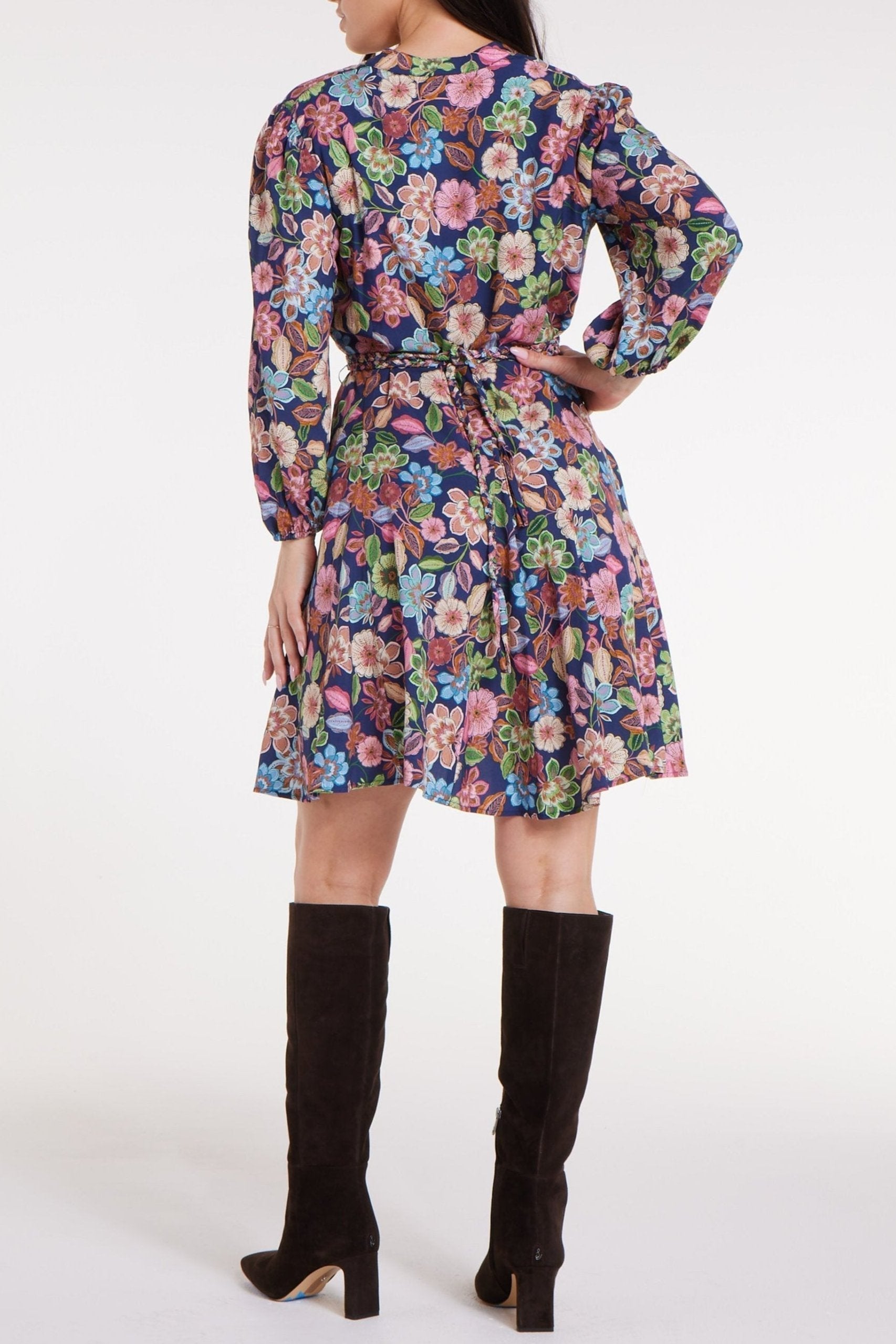 Back view of Gayle Belted Collard Mini Dress in Navy Floral showing tie belt and flowy skirt. Stylish floral mini dress by Hermoza for casual wear.