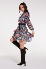Side view of Gayle Belted Collard Mini Dress in Navy Floral with flared hem and navy belt, styled with heeled boots. Feminine floral dress by Hermoza.