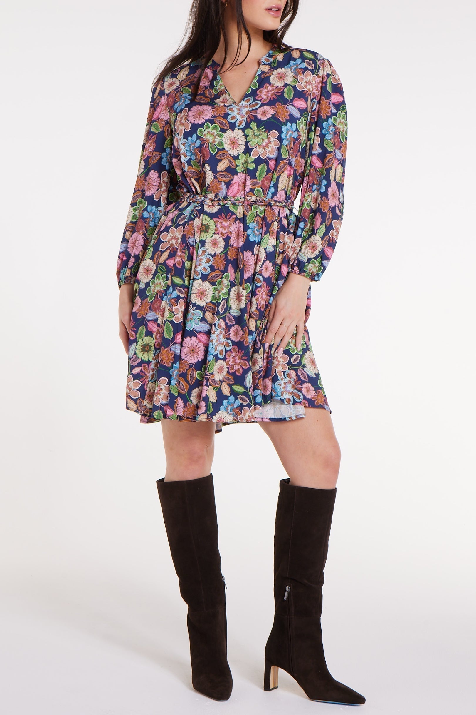 Gayle Belted Collard Mini Dress in Navy Floral with puff sleeves and V-neck, styled indoors with vintage decor. Elegant floral dress by Hermoza.