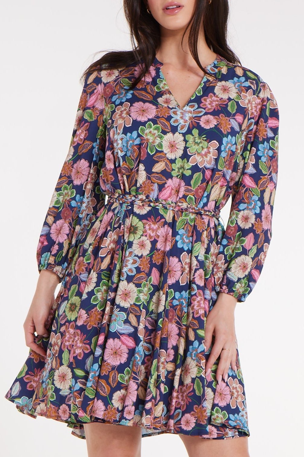 Close-up of Gayle Belted Collard Mini Dress in Navy Floral highlighting floral print, V-neckline, and belted waist. Chic Hermoza dress for any occasion.