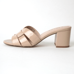 Nori Beige Patent Sandals with geometric crisscross straps and chunky block heels in glossy finish, ideal for stylish summer outfits.